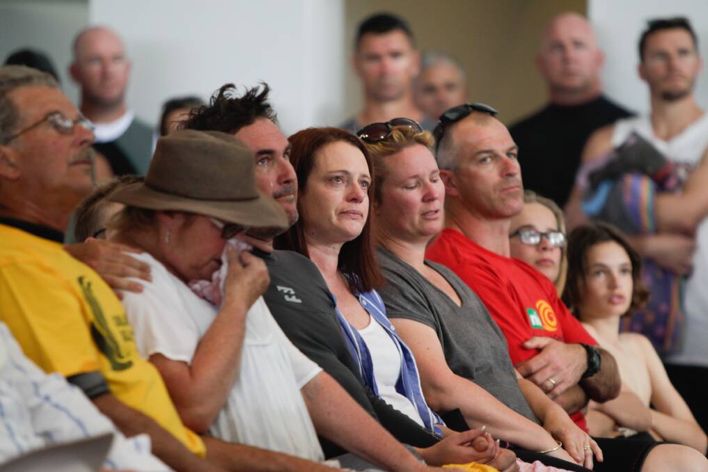 LOSS: Friends and relatives of Dean Mercer react to the service, at Thirroul Surf Life Saving Club. Pictures: Georgia Matts