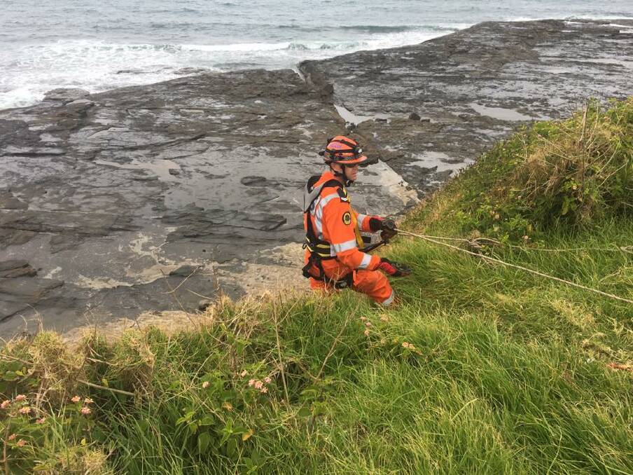 An SES volunteer descends down the cliff face. Picture: NSW SES Kiama Unit