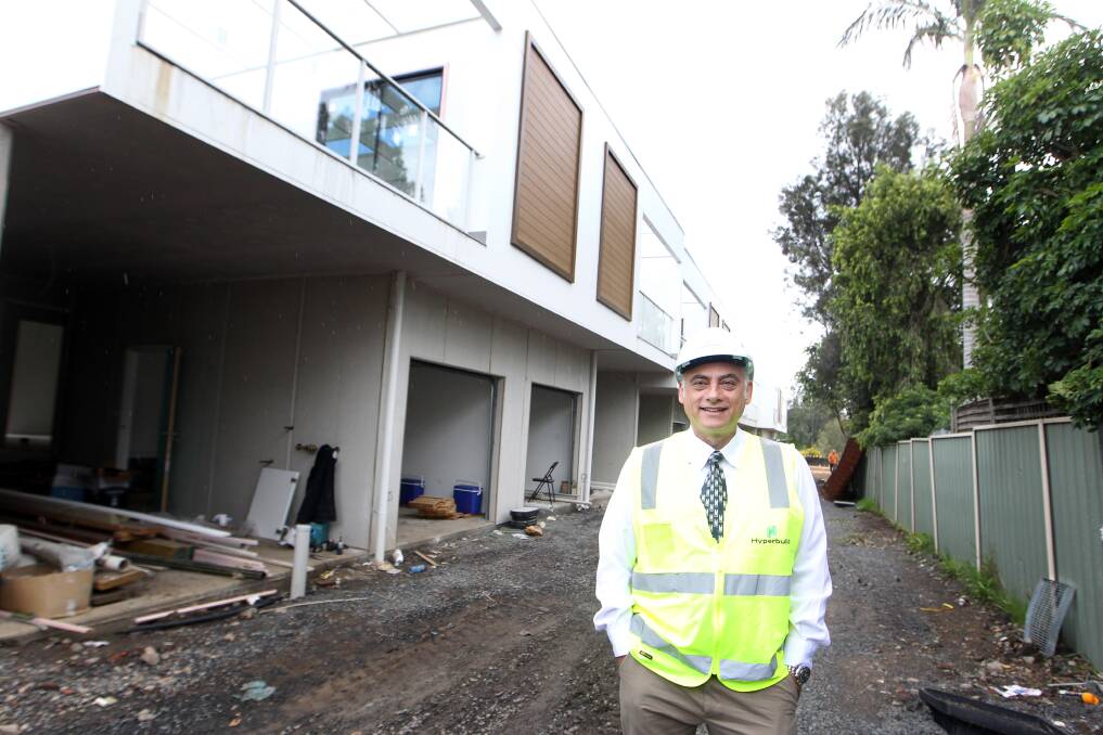 NEW BEGINNINGS: Hyperbuild’s Theo Pasialis in front of the first homes at Albion Park Rail to be made available to low/middle income earners through a partnership with BuyAssist Australia. Picture: Sylvia Liber