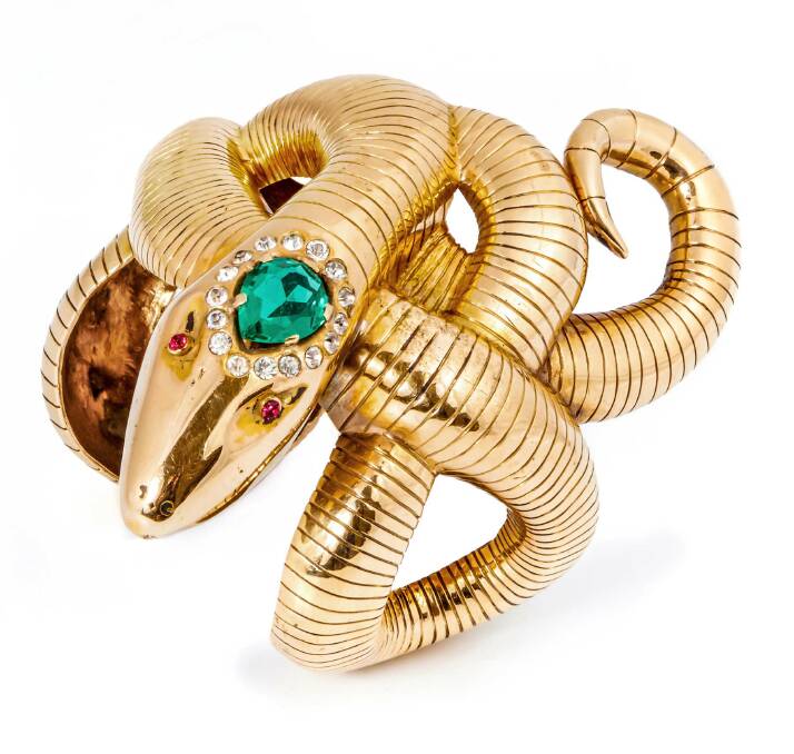 BLING: A yellow gold cuff bracelet in the form of a coiled snake was made for Rita Hayworth in Down To Earth in 1947. Photo: Julien's Auctions.
