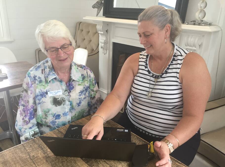 NEWS TIPS: CWA publicity officer Pat Hughes learns about contributing stories online from Southern Highland News editor Jackie Meyers.