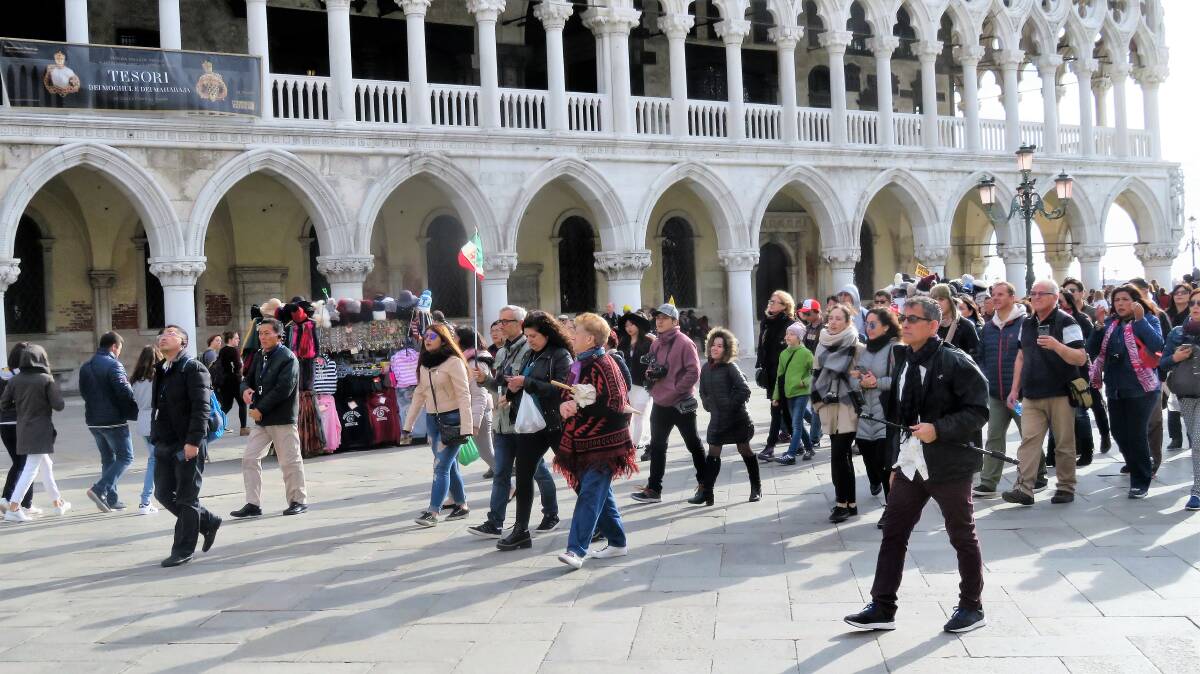 INVASION: Another herd of tourists marches into Piazza San Marco, armed with selfie sticks and a resolve to have ‘done Venice’ before the sun sets. Photo: Geoff Goodfellow.