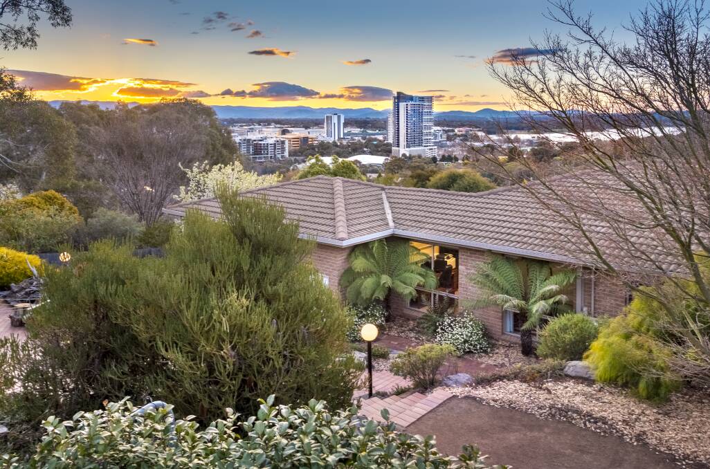 SPECTACULAR SETTING: The three-bedroom home backs onto a reserve, and enjoys stunning views over Belconnen and out to Lake Ginninderra.
