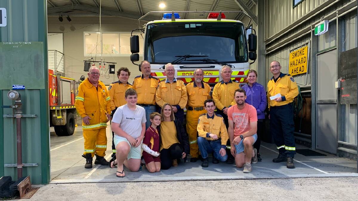 UNITED: Representatives from Robertson RFS and Robertson Hockey Club got together to capture the moment of the generous donation.