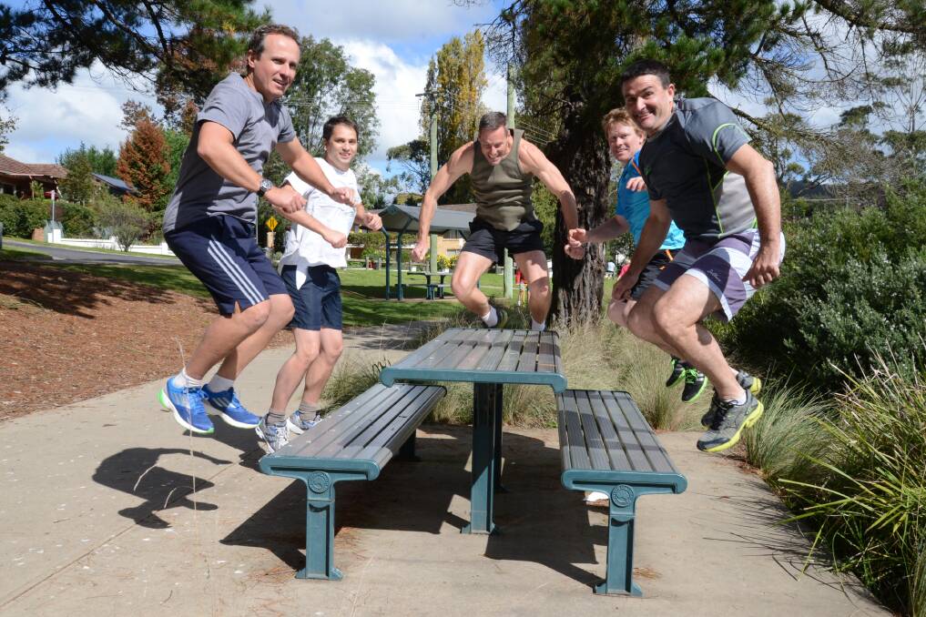 Andrew Mevissen, Matt Coady, Murray Hamer, Daniel Weekes and Rick Mooney (not in order) prepare for the Tough Mudder competition on November 15 and 16 with a few box jumps. 	Photo by Roy Truscott