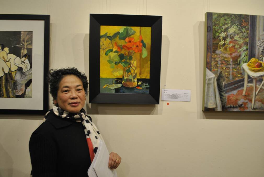 Winner of the Pirtek Still Life Prize Miriam Kin-Yee with her painting 'The Gift Again'. Photo by Claire Fenwicke