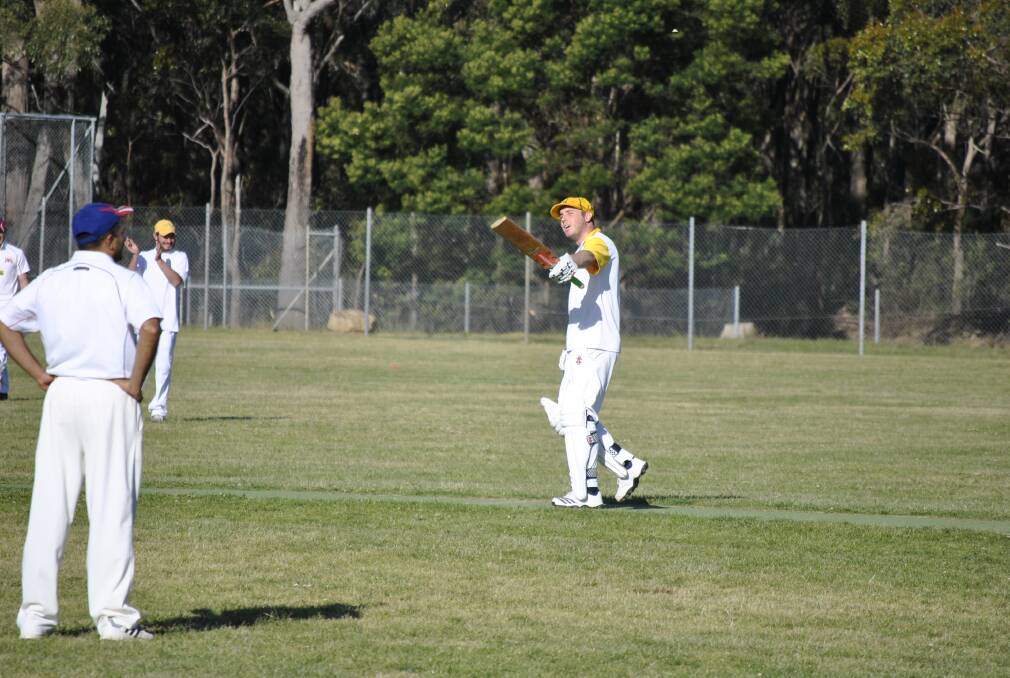 Hill Top s Chris Packer raises his bat after reaching his century on Saturday.  
						   Photo by Josh Bartlett