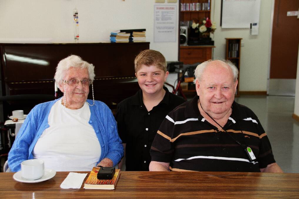 Ben Brownlee-Roberts, 15, with residents at Harbison Care. Photo supplied