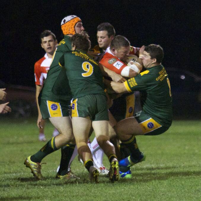 Moss Vale's Robbie Payne battles against a group of Mittagong Lions during the 2015 season. Photo by Daniel Bennett