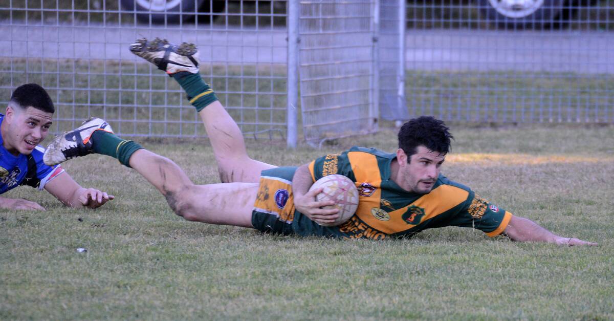 Ryan Borg slides over the try line to score in Mittagong's 70-4 win over Appin on Sunday. 	Photo by Roy Truscott