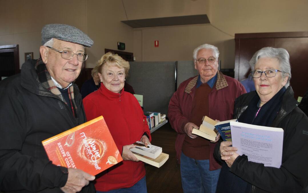 Peter Papps, Ilma and Ron Cunnew and Judy Papps scoured the rows for books for their grandchildren on Saturday. Photo by Claire Fenwicke