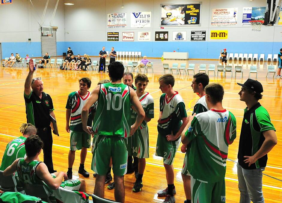 Coach Kev Campbell gives instructions to the Moss Vale Magic players on Saturday night. Photo courtesy of Noel Rowsell