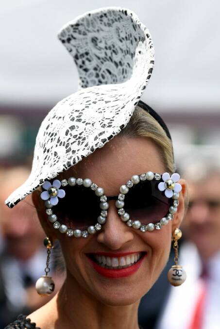 Cool shades in the Birdcage on Victoria Derby day at Flemington Racecourse in Melbourne, Saturday, November 4, 2017. (AAP Image/Joe Castro)
