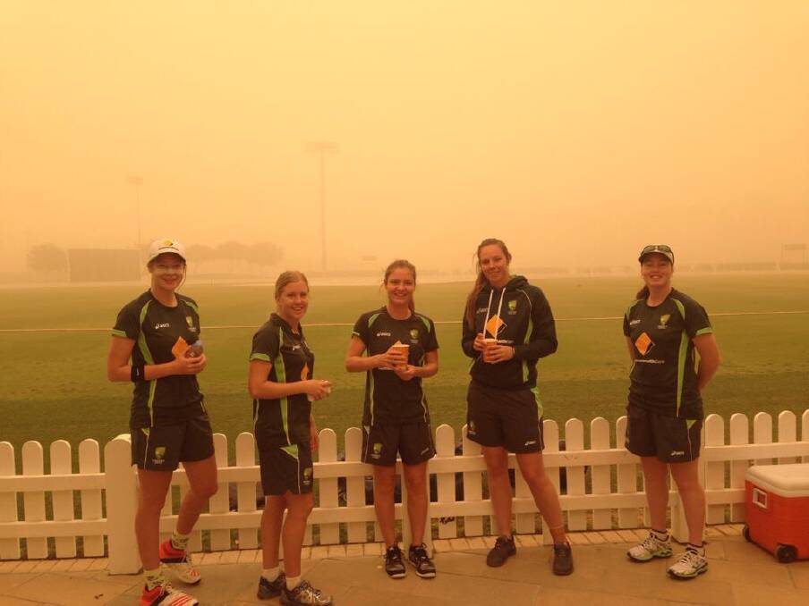Australian Shooting Stars cricketers, including Bowral's Lauren Cheatle (left), are forced off the field due to a standstorm in Dubai.