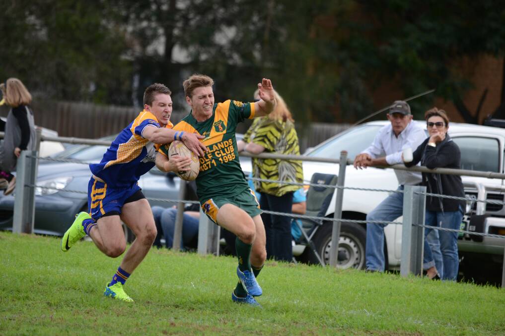 Bo Lander tries to get away from a Kangaroos defender. 
	Photo by Roy Truscott