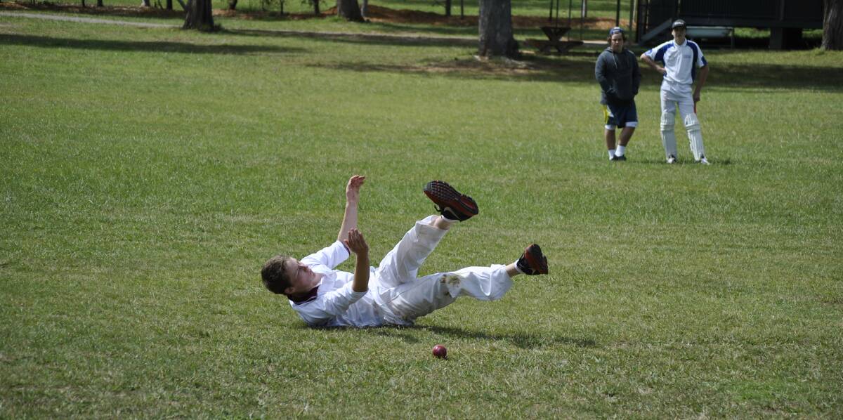Chevalier cricketer Lachlan Larney-Dawson dives to save a boundary on Saturday. 						  