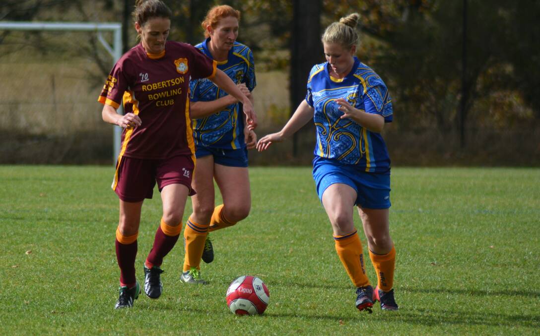 Bundanoon's Pippi Martin (right) races an opponent to the ball during a recent game. Photo by Mindy Hindmarsh