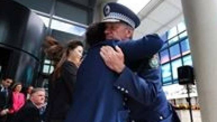 NSW Police Commissioner Andrew Scipione comforts Selina Cheng at Friday's ceremony. Photo: NSW Police