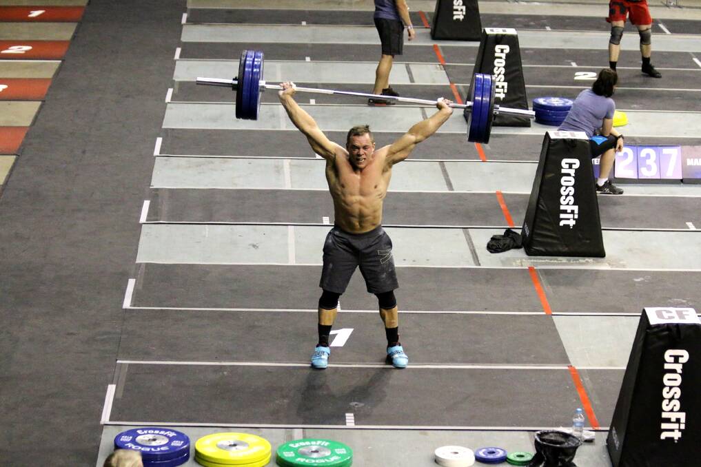 Ben Garard completes a one-rep-max snatch on day two of the Pacific Regional in Wollongong. 	      				    Photo by Craig Horne
