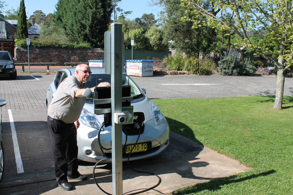 John Ward plugging in his car at the Southern Highlands Welcome Centre after driving from Sydney on one charge. Photo by Jen Walker