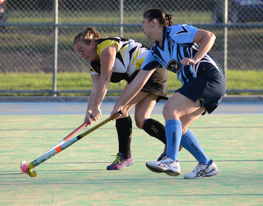 Robertson's Natalie Wilson tries to get the ball past Bowral's Sarah Stokes. Photo by Roy Truscott