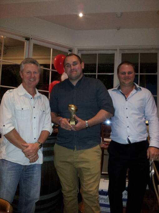 Anthony Phelps (centre) receives the reserve grade player s player and most valuable player awards, along with the most tries and highest point scorer awards, from Owen Saunders and Damian Barton.