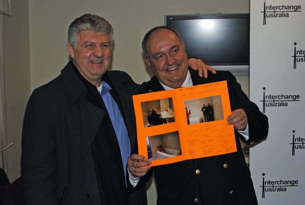 CEO of Interchange Australia Mark Populin and Springett Foundation trustree Tony Springett with a thank you card from Springett House residents for the newly renovated bathrooms. Photos by Ainsleigh Sheridan