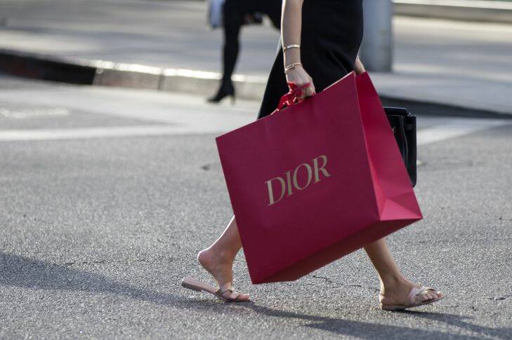 A shopper carries a Christian Dior SE bag on Rodeo Drive in Beverly Hills, California, U.S., on Saturday, Dec. 9, 2017. The U.S. Census Bureau is scheduled to release retail sales figures on December 14. Photographer: Troy Harvey/Bloomberg