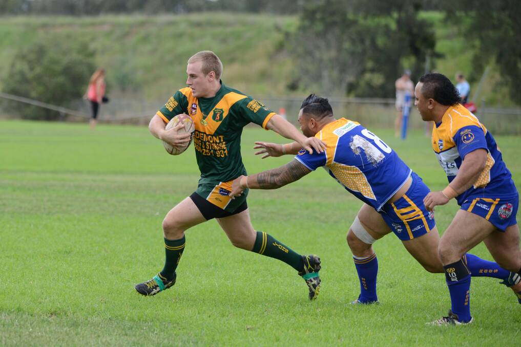 Warwick Carter breaks away from the Campbelltown defence.	Photo by Roy Truscott