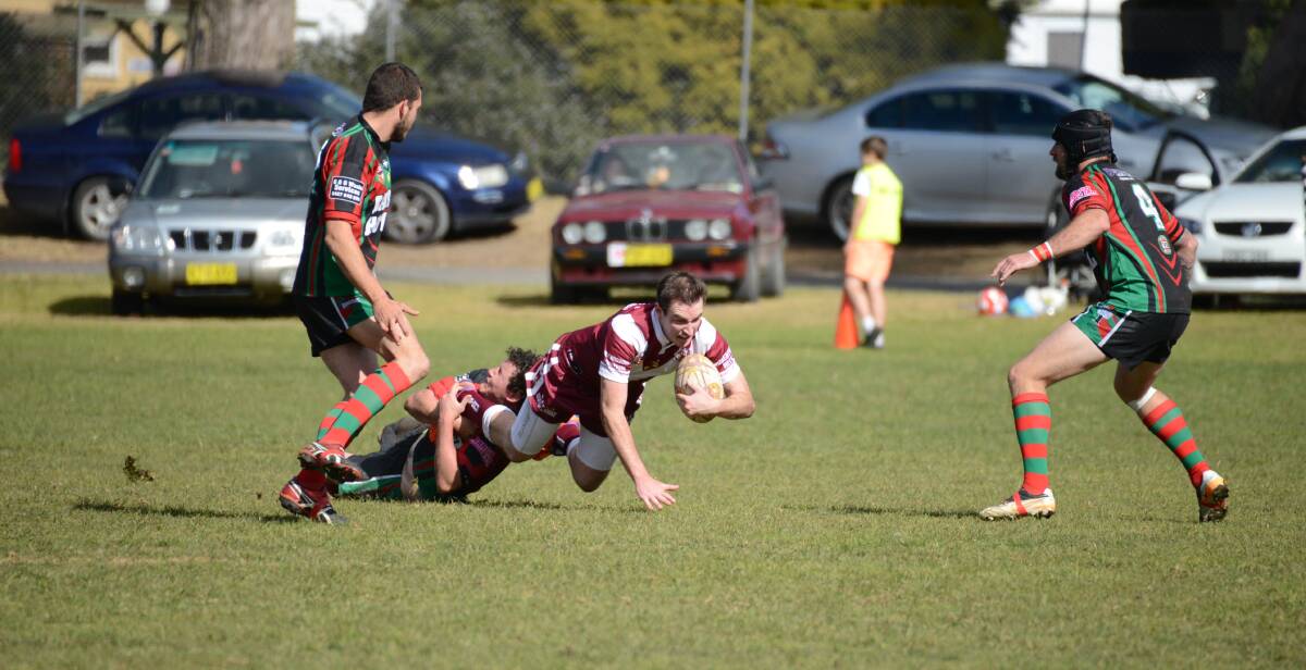 Robertson's Sam Goodfellow tries to get out of a tackle as he goes to ground. Photo by Roy Truscott
