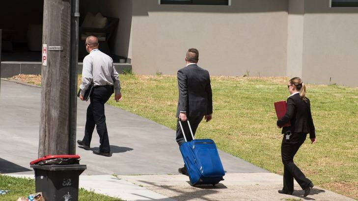 Detectives return to the crime scene at Georges Hall on Wednesday. Photo: Fairfax Media