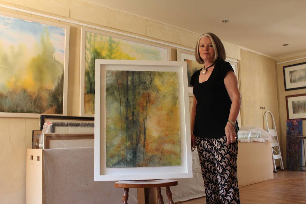 Elizabeth Young in her Bowral studio with one of the paintings she will exhibit at the South Hill Gallery. Photo by Megan Drapalski