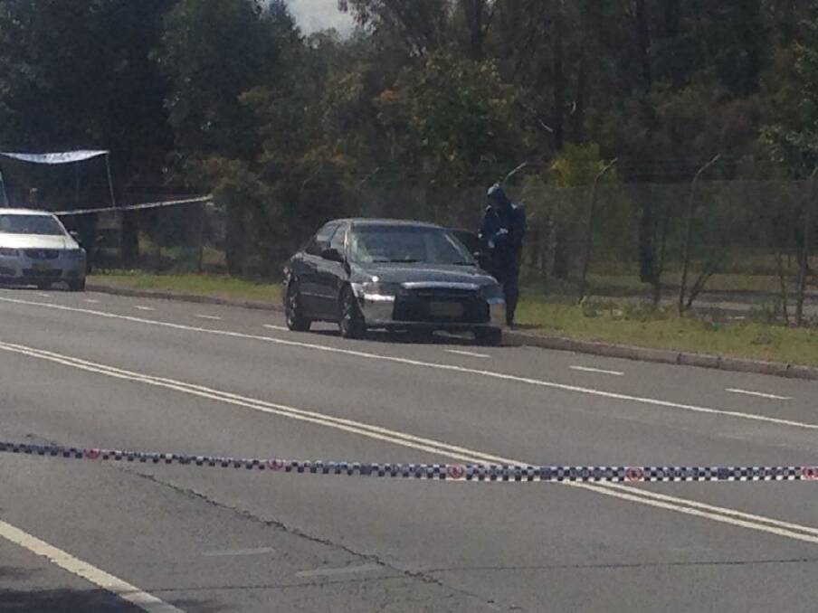 Evidence: Police are examining the car abandoned on East Street, Lidcombe. Photo: Marcus Strom
