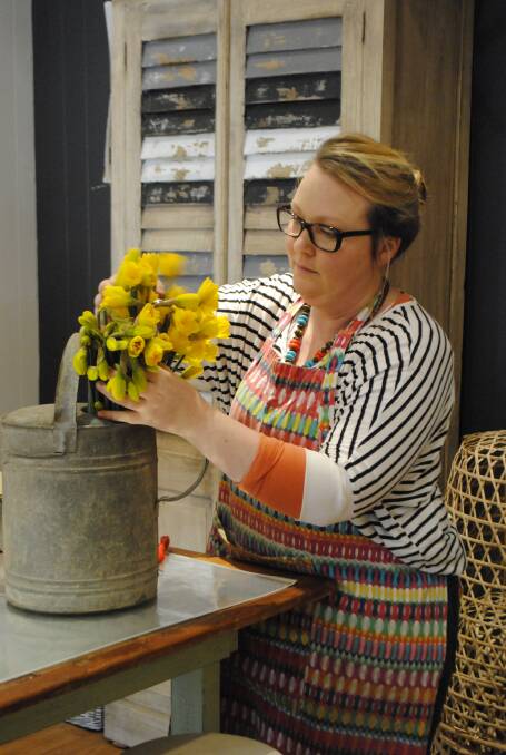 Kylie Power of Flowers On Argyle in Moss Vale arranges daffodils, the floral symbol of the next Cancer Council Australia fundraiser, to be held today. Photo Ainsleigh Sheridan