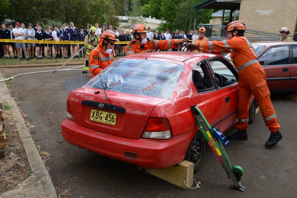SES officers demonstrate rescue procedures while Bowral High School students watch on. Photos by Roy Truscott 