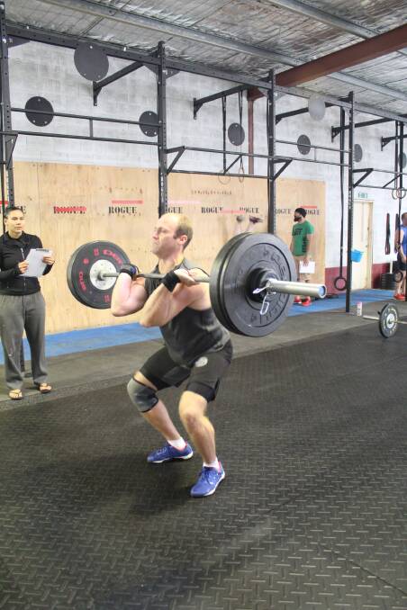 James Allen from CrossFit Southern Highlands drops under the bar.