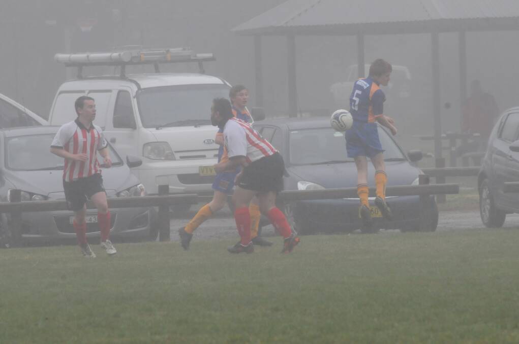 Bundanoon's Rhys Cole tries to see where his header has gone in the fog.  
	Photo by Lauren Strode