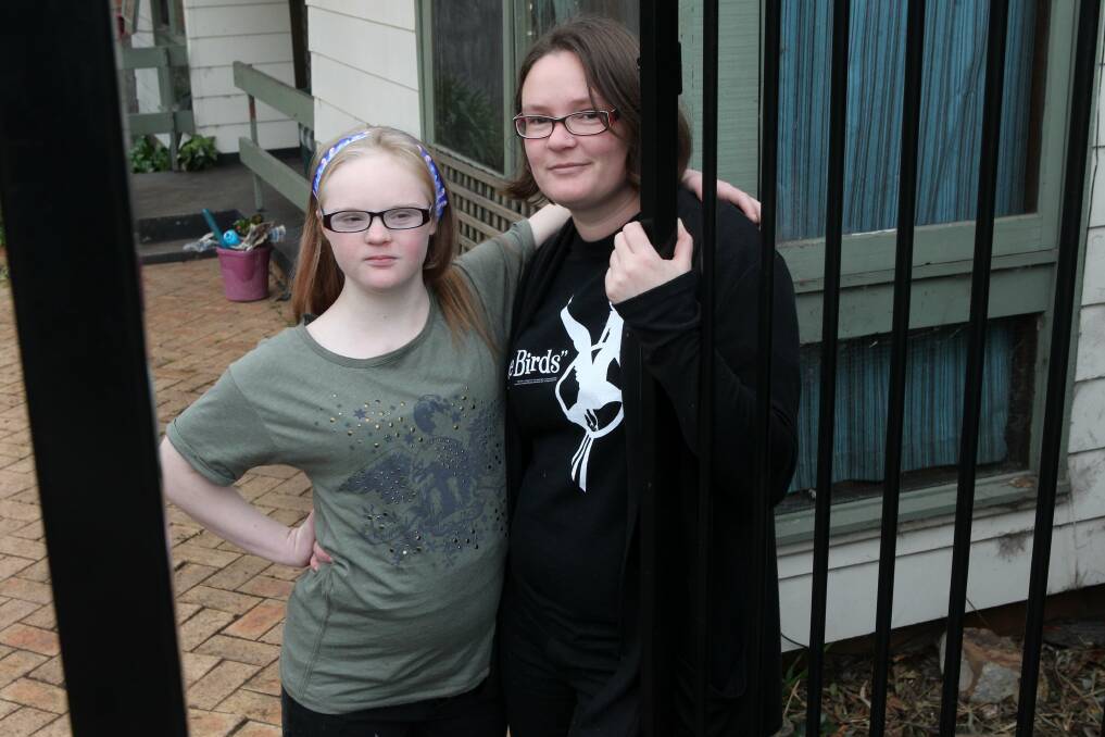 Faith Mason, 15, with her mum, Sophie, beside their new security fence. Picture: GREG TOTMAN
