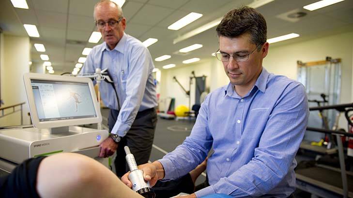 Physiotherapy professor Gordon Waddington and Assistant Professor Phil Newman with the only Storz Medical Duolith SD1 machine, used to treat shin splints. Photo: Jay Cronan