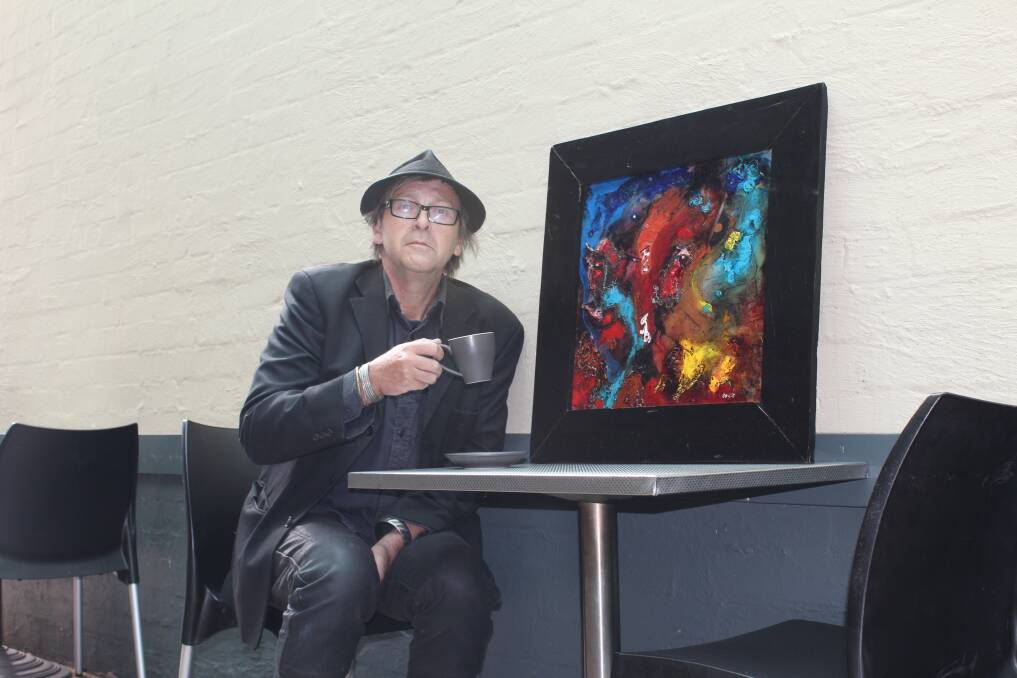 Local artist Sean Cuffe with his artwork The Pond.  
	Photo by Megan Drapalski