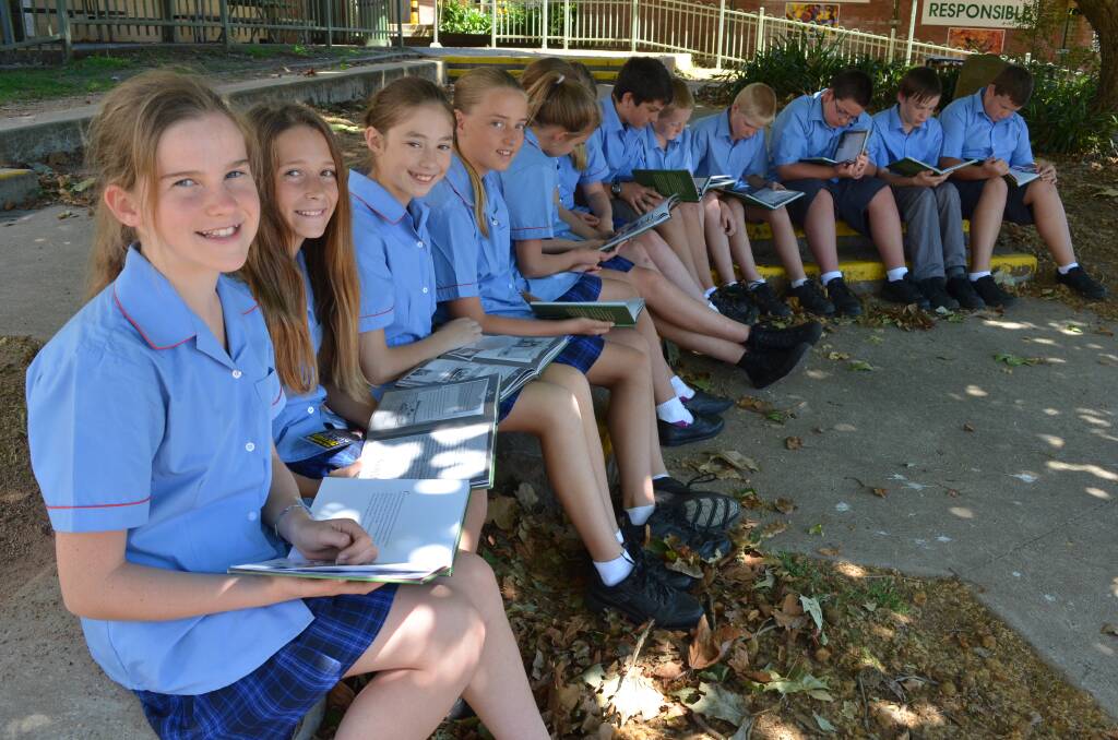 Year 7 Moss Vale High School students Zoe Drayton, Clare Middleton, Zoe Bosevski and Amy Webb with their classmates reading The Light Horse Boy.  
	Photo by Emma Biscoe
