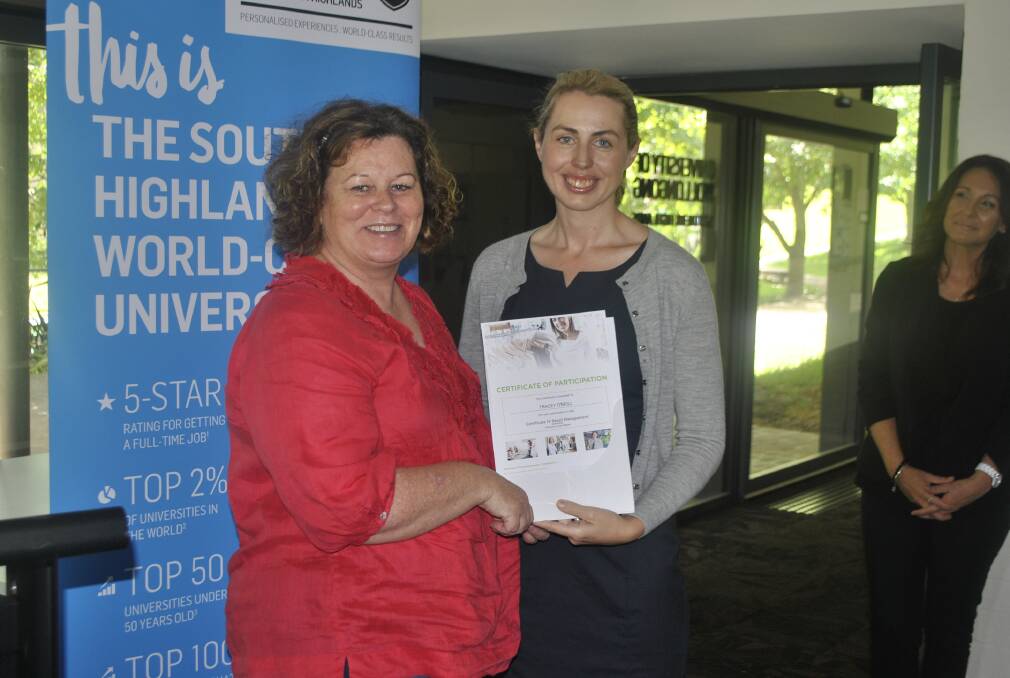 Tracey O'Neill was presented with a certificate four in retail management by University of Wollongong pathways coordinator Keirin McCormack.