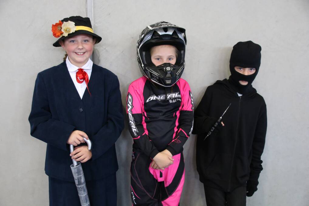 Bridget Connors from Year 4 dressed as Mary Poppins with dirt bike rider Zoe Turner and Jeremy Henderson, dressed for 52-Storey Treehouse.