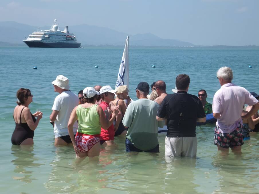 SeaDream's guests are quickly lured from beach to that in-water bar. Photo by David Ellis