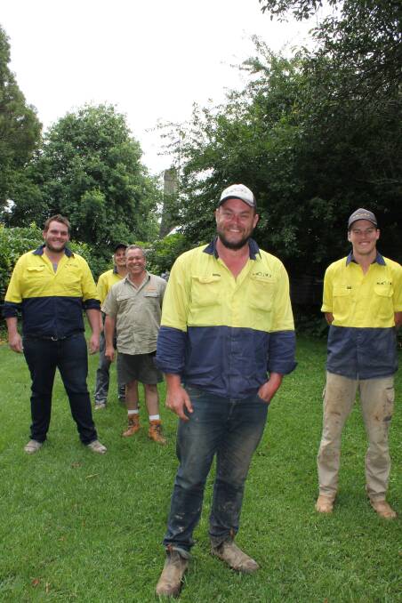 Mick Conway with his landscaping team. Photo by Jen Walker