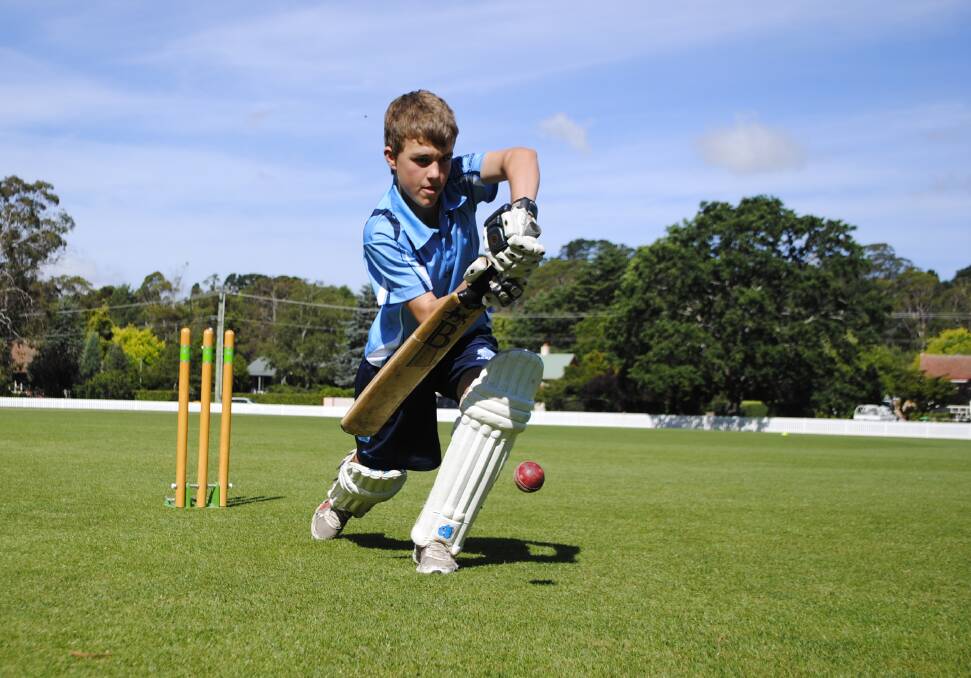 Bowral's Billy McGuinness, 13, focuses as he practises a defensive shot at Bradman Oval. Photo by Josh Bartlett