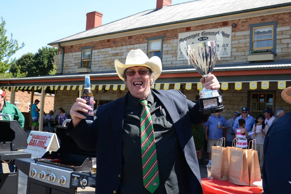 Greg Schofield celebrates being crowned the sizzler of the most satisfying sausage. 	Photo by Roy Truscott
