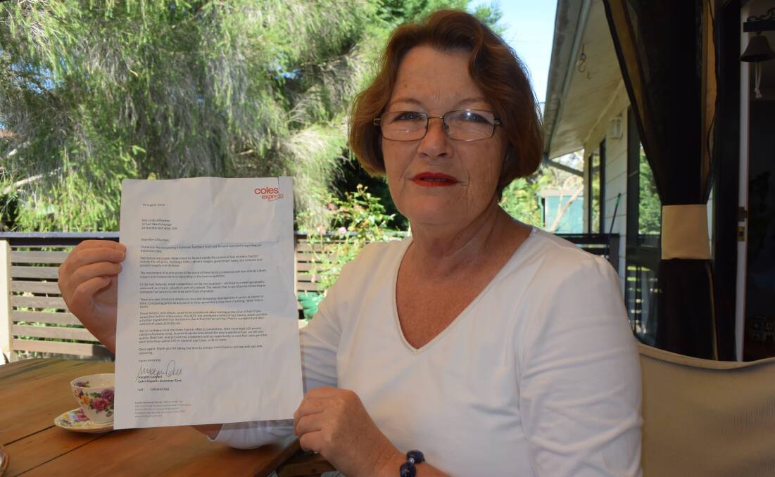 YOU’RE KIDDING: Surf Beach’s Lynda Gilfeather with the reply she received from Coles Express to her petrol price inquiry.