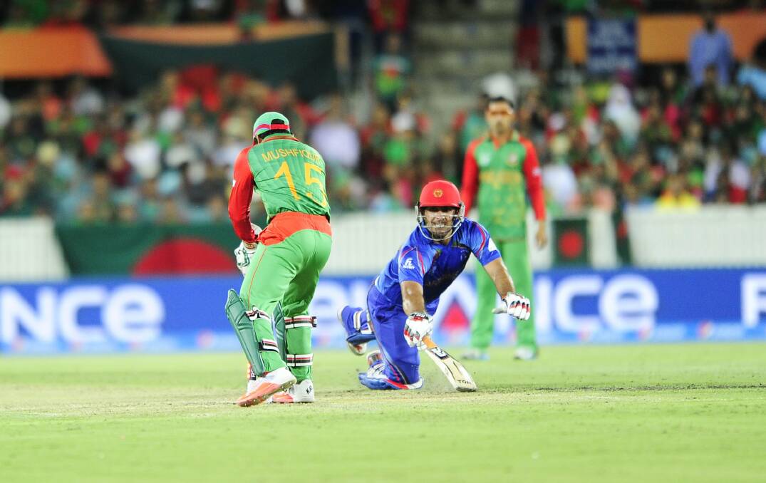 Afghanistan take on Bangladesh in the ICC Cricket World Cup at Manuka Oval in Canberra. Afghanistan batsman Shinwari Samiullah is run out by Bangladesh wicket keeper Rahim Mushfiqur.  Fairfax image.