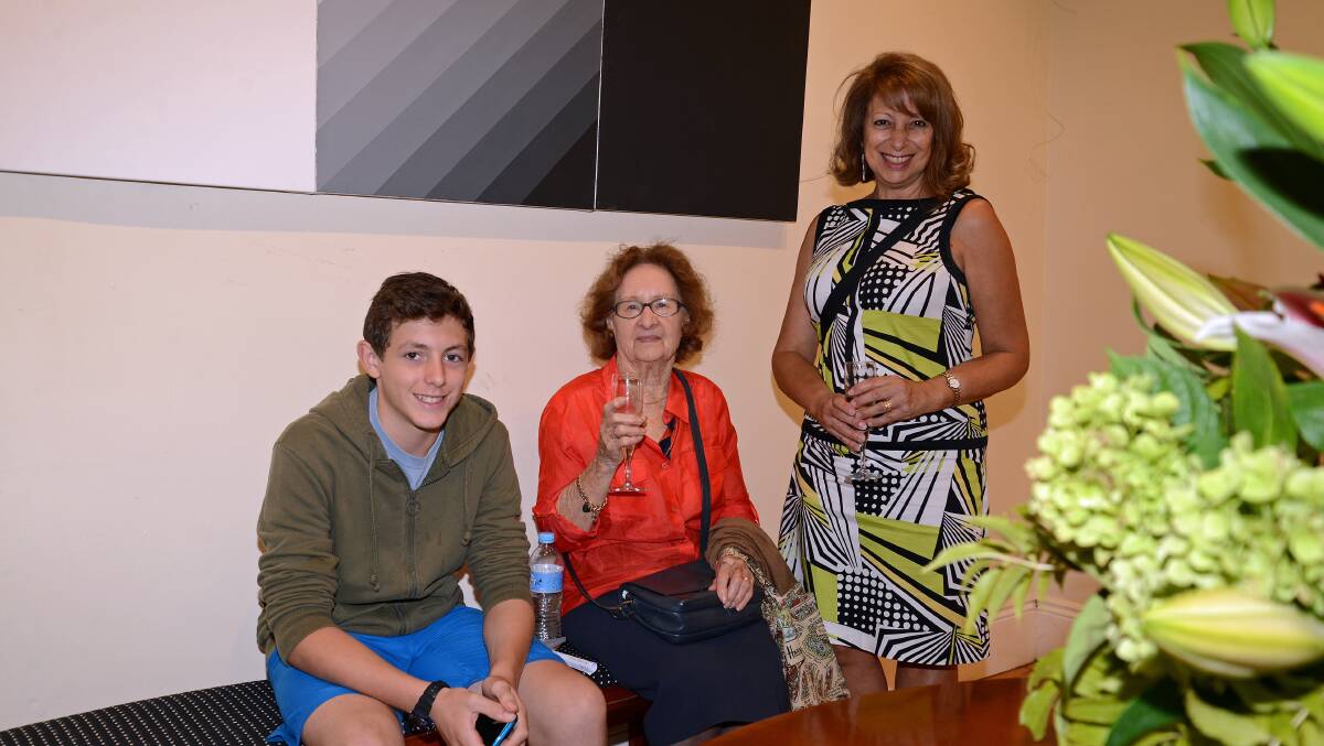 Alex (13) and Margaret Bruce with Lorraine Kypiotis under one of the painting on display.
Photo by Roy Truscott